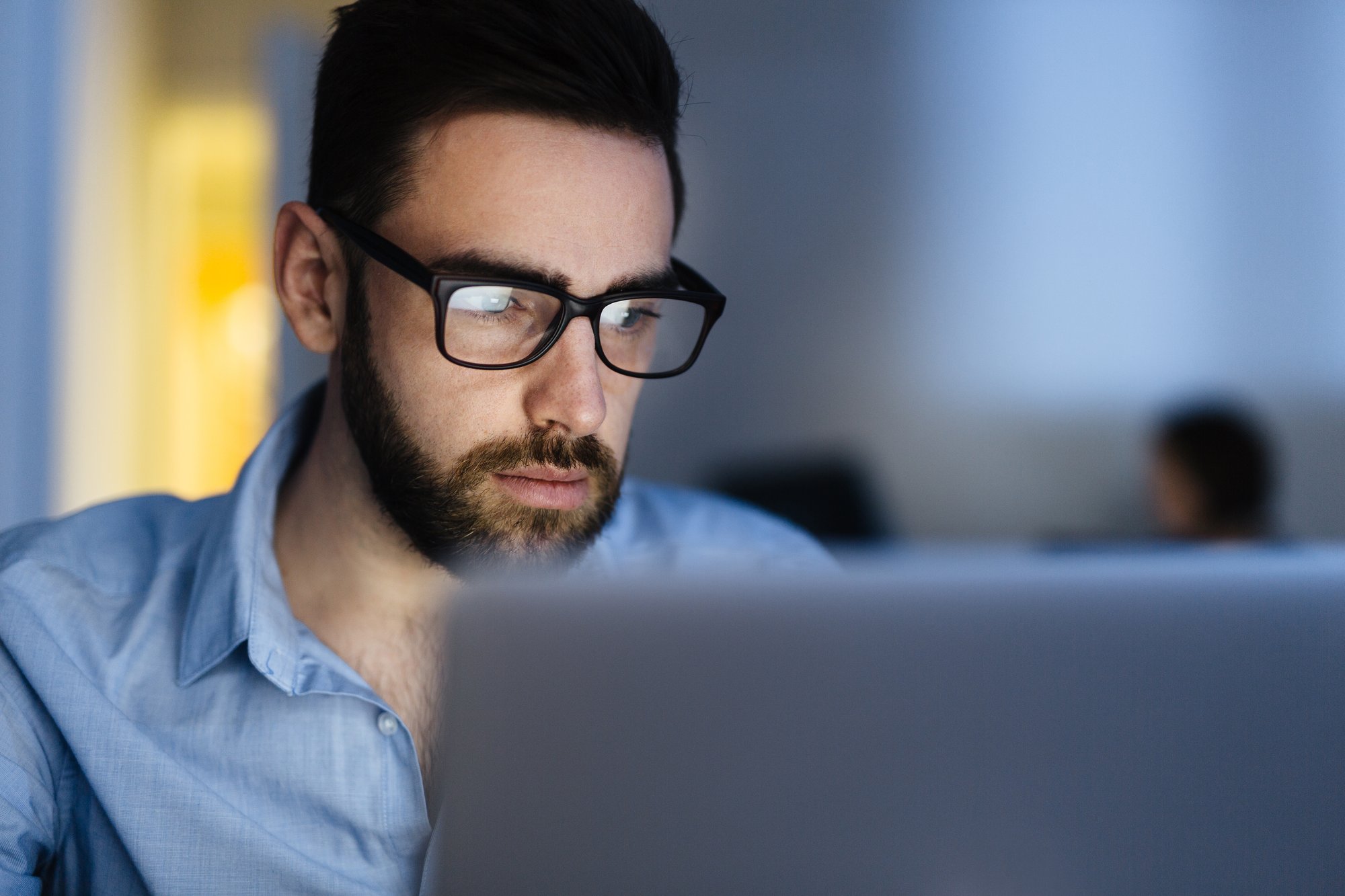 man looking at digital assets on computer