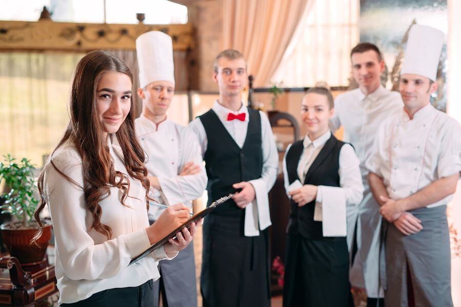 Restaurant employees meeting in a restaurant and in uniform