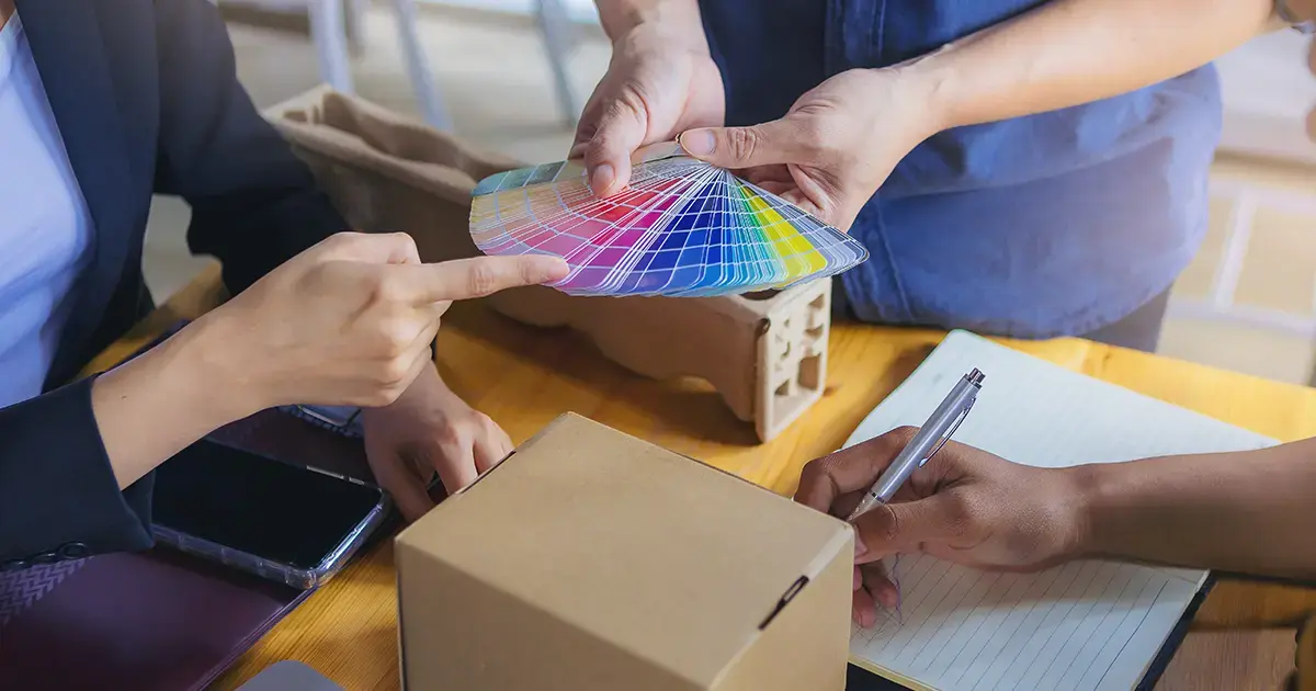 Marketing team reviewing packaging and evaluating color swatches